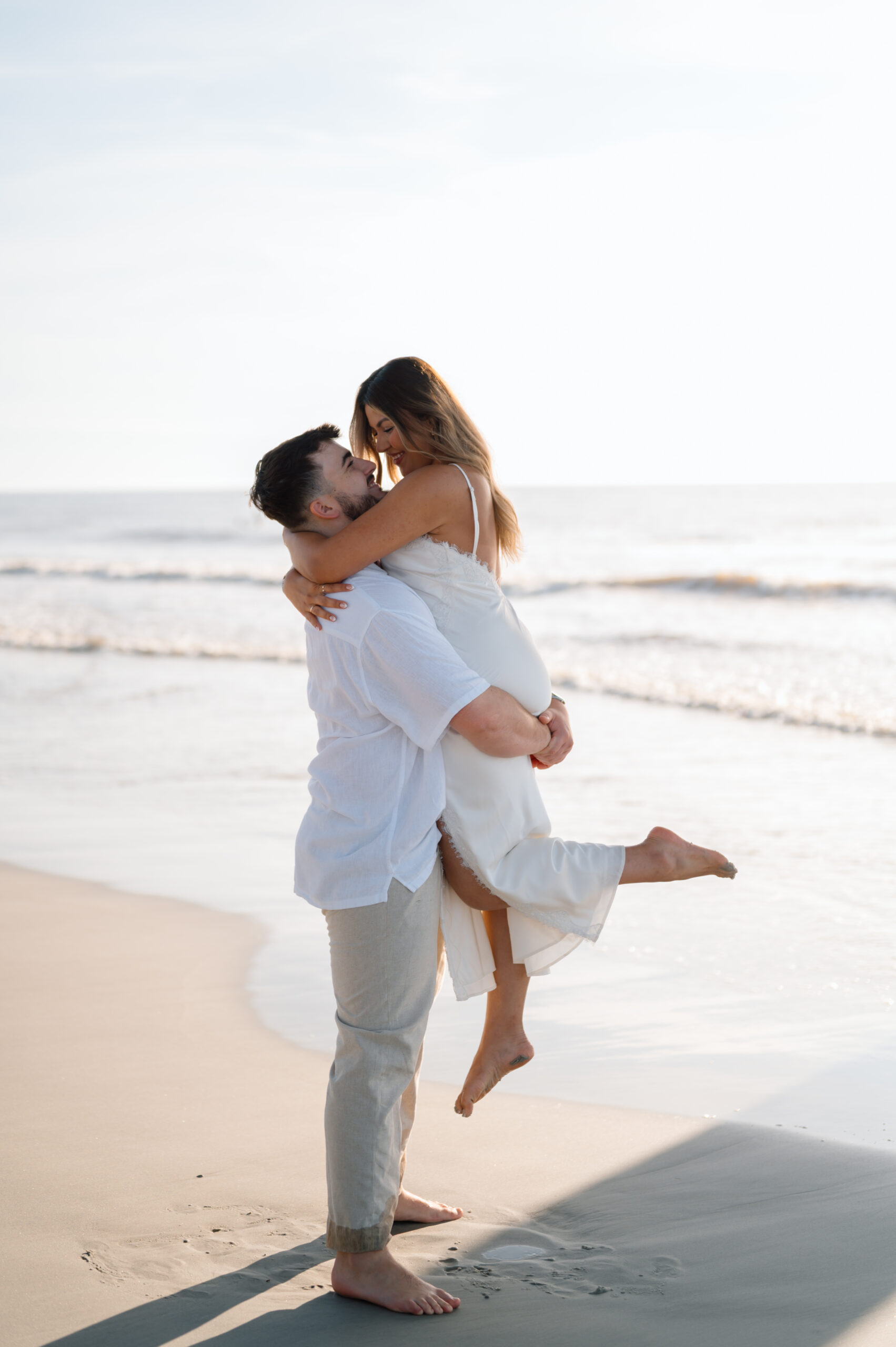 couple cuddling up on the beach